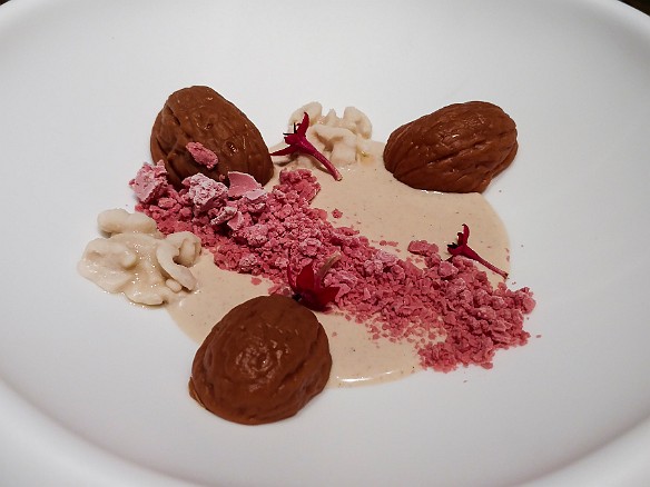"Intxausalsa" is traditionally a walnut cream dessert that comes from the Basque region. Here it is paired with walnut flavored chocolate molded in the shape of walnuts. The garnish was some type of berry liquor flash frozen in liquid nitrogen. Mar 19, 2016 11:19 PM