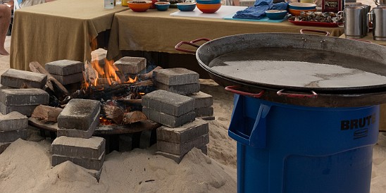 CaymanCookout2015Day1-016 The large paella pans are oiled down and waiting to go on the wood fires contained by rings of cinder blocks