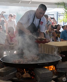 CaymanCookout2015Day1-023 Today's demo is fideuà, a variation on paella that substitutes short toasted pasta instead of rice. Sauteing the lobster is the first step.