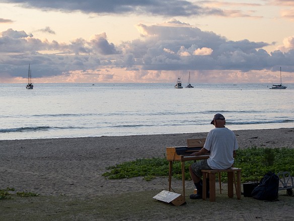 As the sun sets, this guy serenades the beach with his battery powered organ. Have no idea what the galoshes were about... maybe he knew of a tsunami warning that everyone else missed? May 14, 2012 6:58 PM : Kauai