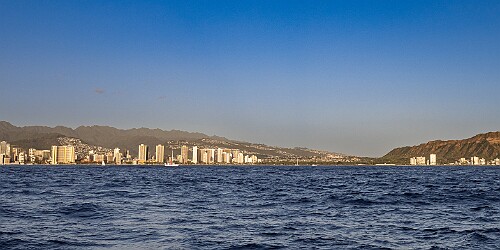 Oahu2026-023 Cruising east off Waikiki towards Diamondhead as the sun starts lowering towards the horizon. The orangish-brown haze along the horizon is the VOG (volcanic...