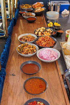 Maxine70thBirthday-028 Colt had been fermenting for days and the banchan started being put out on the counter: kimchi cabbage, kimchi daikon, kimchi cukes, pickled onions, and several...