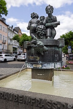 Cochem2025-034 This fountain illustrates an old Cochem fable about the goat that ate the vintner's grapes. The two men are turning a wine press with a goat caught in it. The...