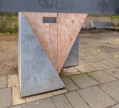 Cologne2025-023 The memorial to the gay and lesbian victims of the Nazis is situated along the banks of the Rhine. It is made of pink and grey granite and is shaped like a pink...