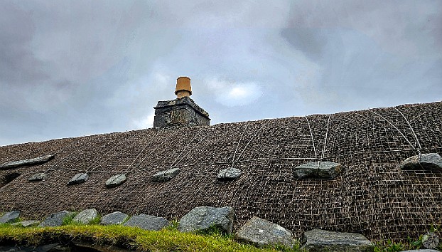 IsleOfLewisHarris2024-012 The thatched roofs held down by netting, ropes, and large stones