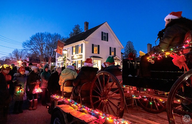 TreesInTheRigging2024-012 Several decorated vehicles parade down the street and lead the crowd in Christmas carols